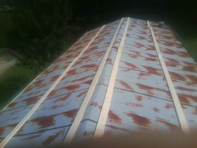 Rusted metal roof panels with new wood purlins before replacement — Storm Damage Roof Repair in Kountze by Roofing Brothers
